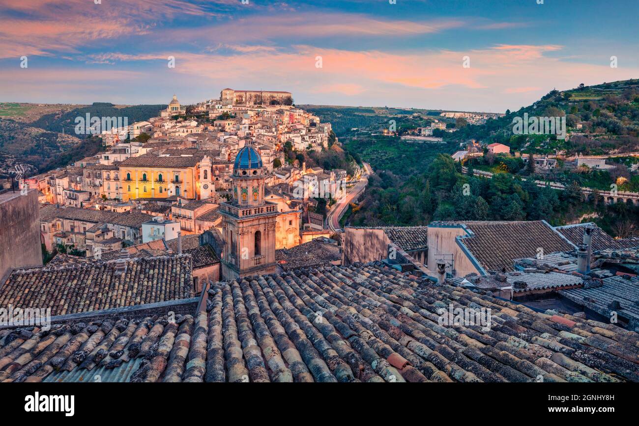 Attractive spring cityscape of Ragusa town with Palazzo Cosentini and Duomo di San Giorgio church on background. Colorful sunset in Sicily, Italy, Eur Stock Photo