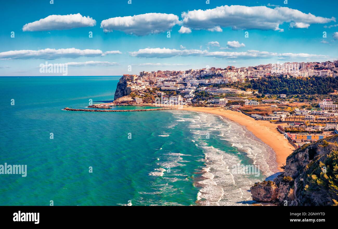 Splendid spring cityscape of Peschici town, Province of Foggia, Italy, Europe. Magnificent morning seascape of Adriatic sea. Top down view. Traveling Stock Photo