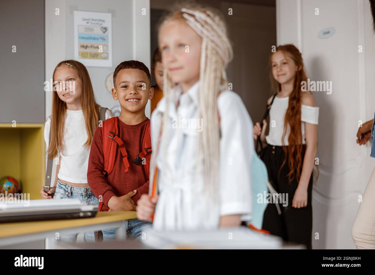 Smiling kids standing in class at school Stock Photo