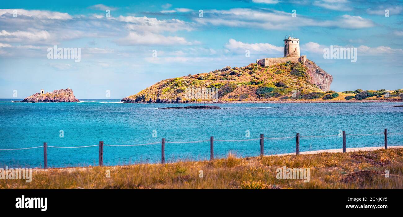 Panoramic summer view of Torre del Coltellazzo o di Sant'Efisio tower. Sunny morning scene of Sardinia island, Italy, Europe. Stunning seascape of Med Stock Photo