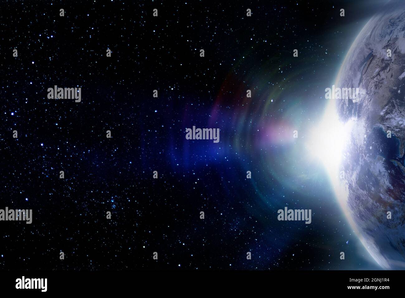 Planet Earth in space and lens flare  from the rising sun. Eelements of this image furnished by NASA. Stock Photo
