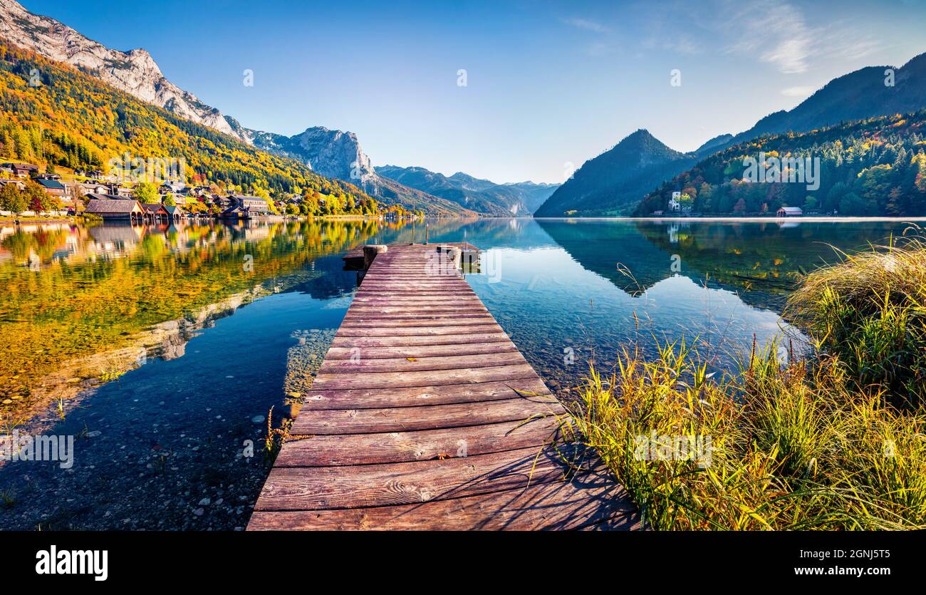Empty wooden pier in a fishing village. Bright sunny day on Grundlsee lake. Calm autumn view of Eastern Alps, Liezen District of Styria, Austria, Euro Stock Photo