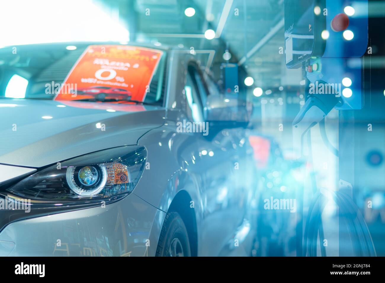 New car parked in luxury showroom with blur electric car charging