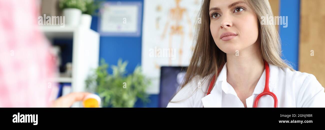 Doctor advises patient on medication intake closeup Stock Photo