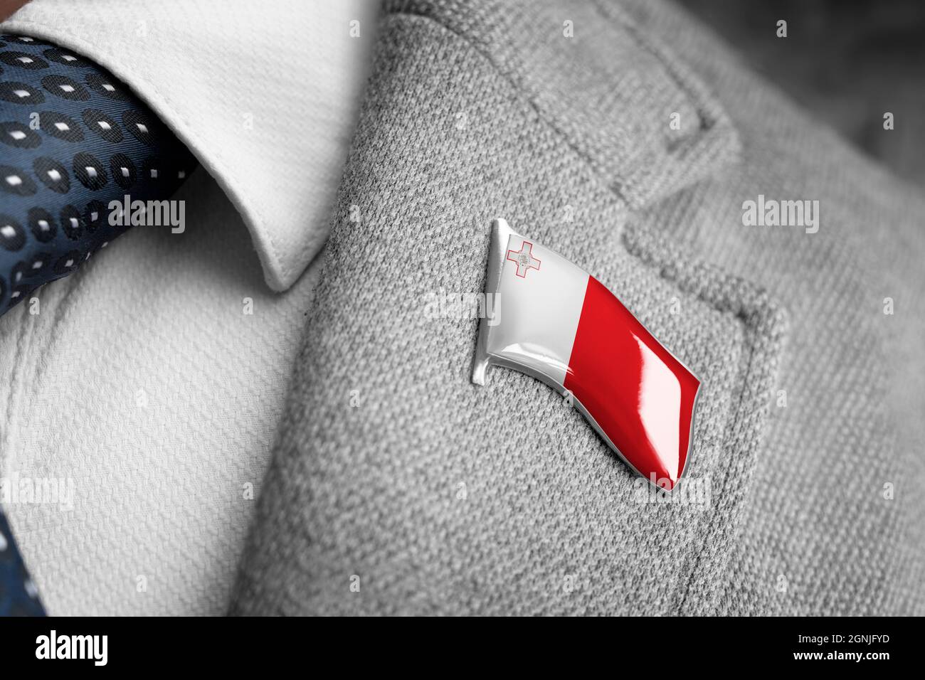 Metal badge with the flag of Malta on a suit lapel Stock Photo