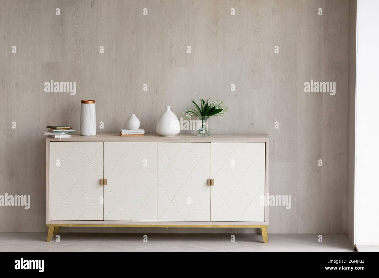 Spit Nevelig commentator Modern commode standing in empty living room Stock Photo - Alamy