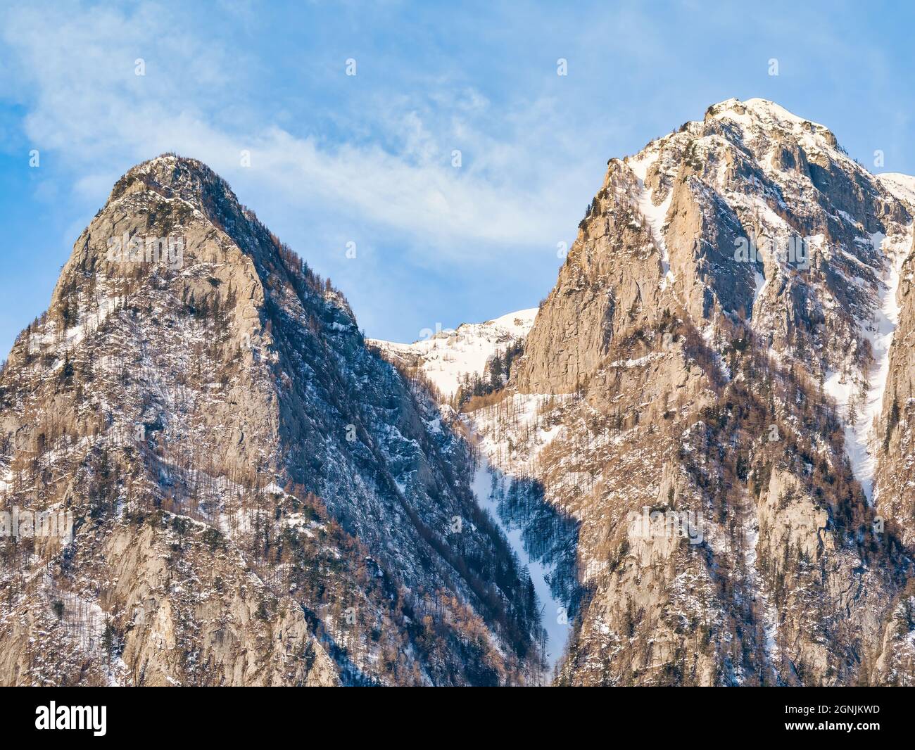 Detail with a pyramid shaped rocky peak covered in snow in the Bucegi Montains, Romania Stock Photo