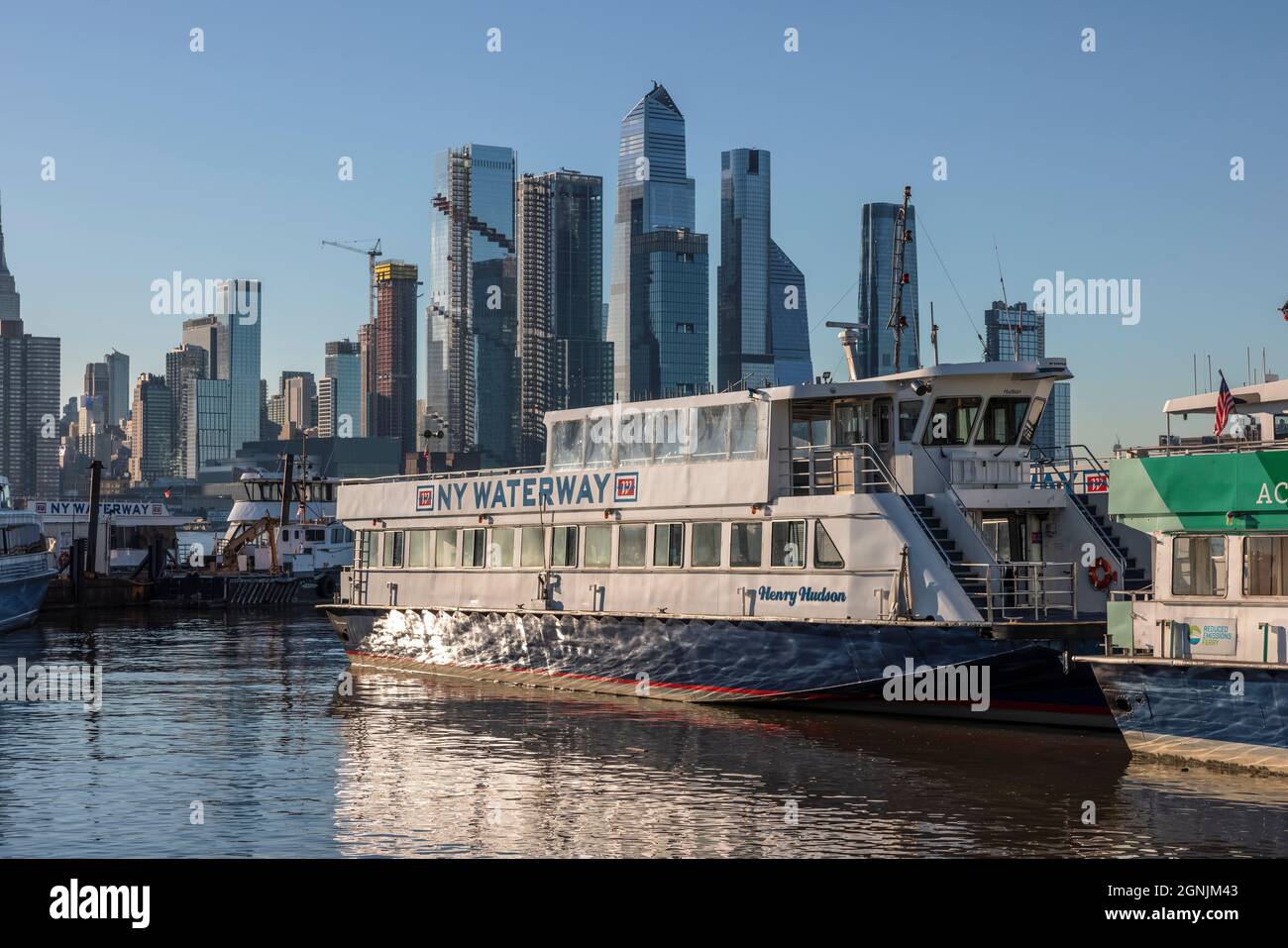 A NY Waterway ferry docked in Weehawken, NJ with the Hudson Yards development in New York City in the background. Stock Photo