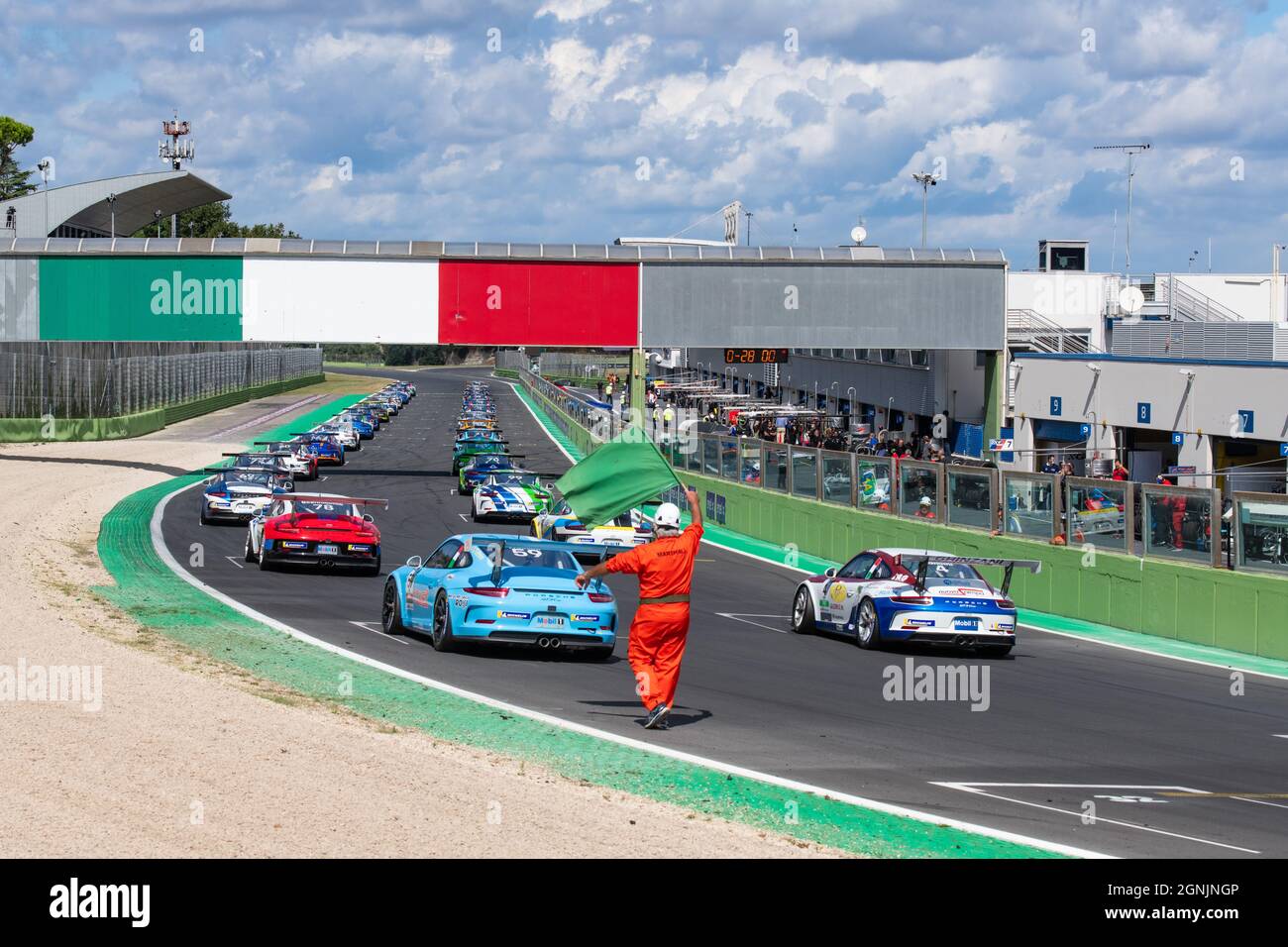 Vallelunga, italy september 19th 2021 Aci racing weekend. Green flag waving at car race starting grid rear view Porsche Carrera Cup Stock Photo