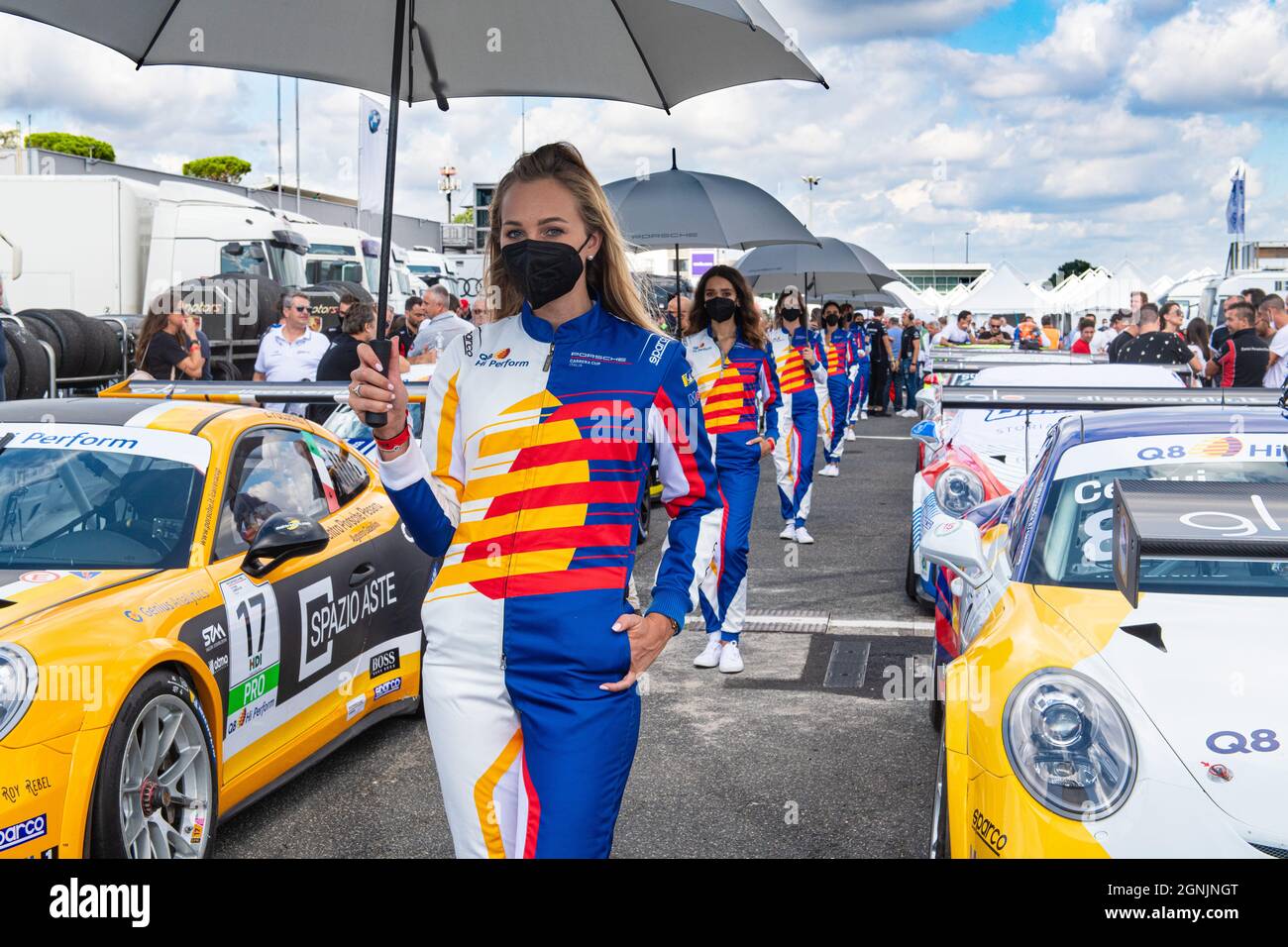 Vallelunga, italy september 19th 2021 Aci racing weekend. Girls aligned with many race cars in circuit paddock Porsche carrera show Stock Photo