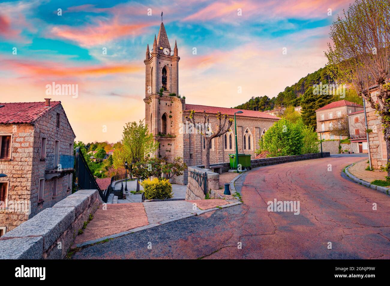 Amazing evening cityscape of Zonza town with Eglise paroissiale de l'Assomption church, commune in the Corse-du-Sud department of France. Majestic sun Stock Photo