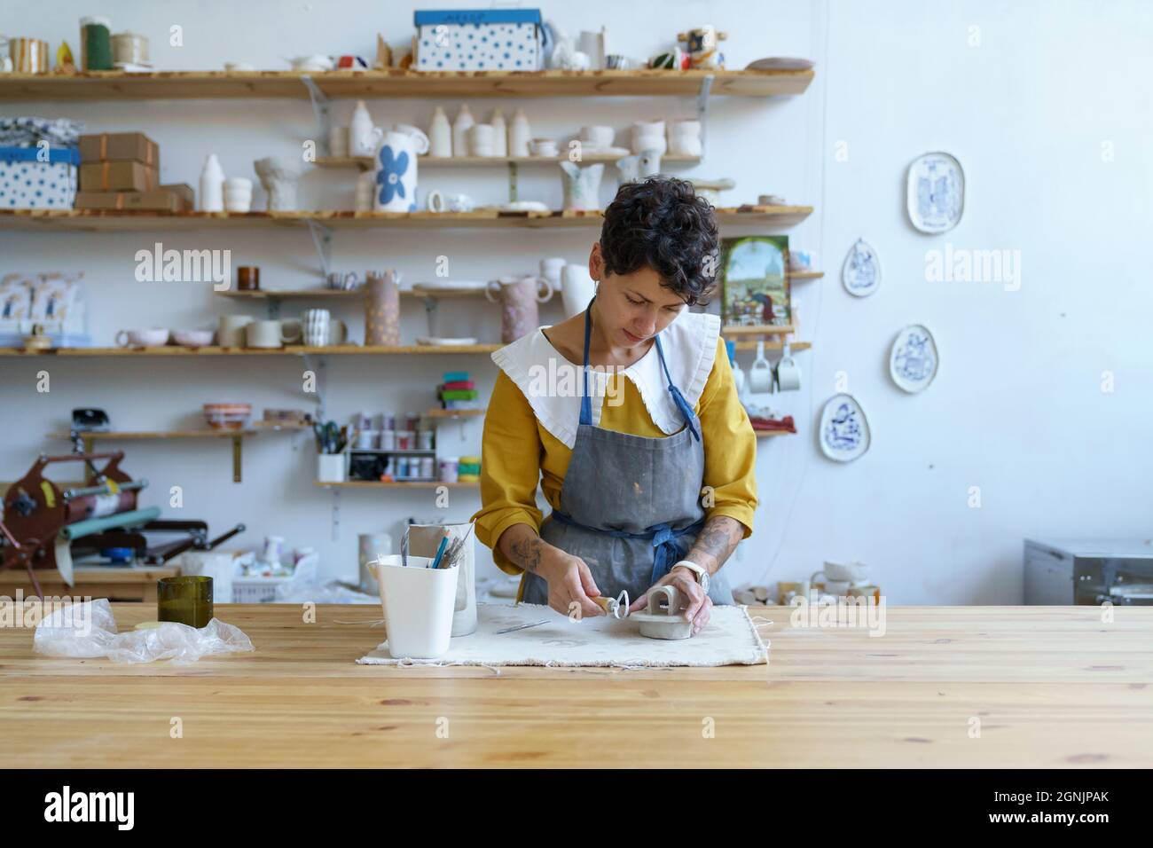 Creative process in pottery studio young artist girl modeling