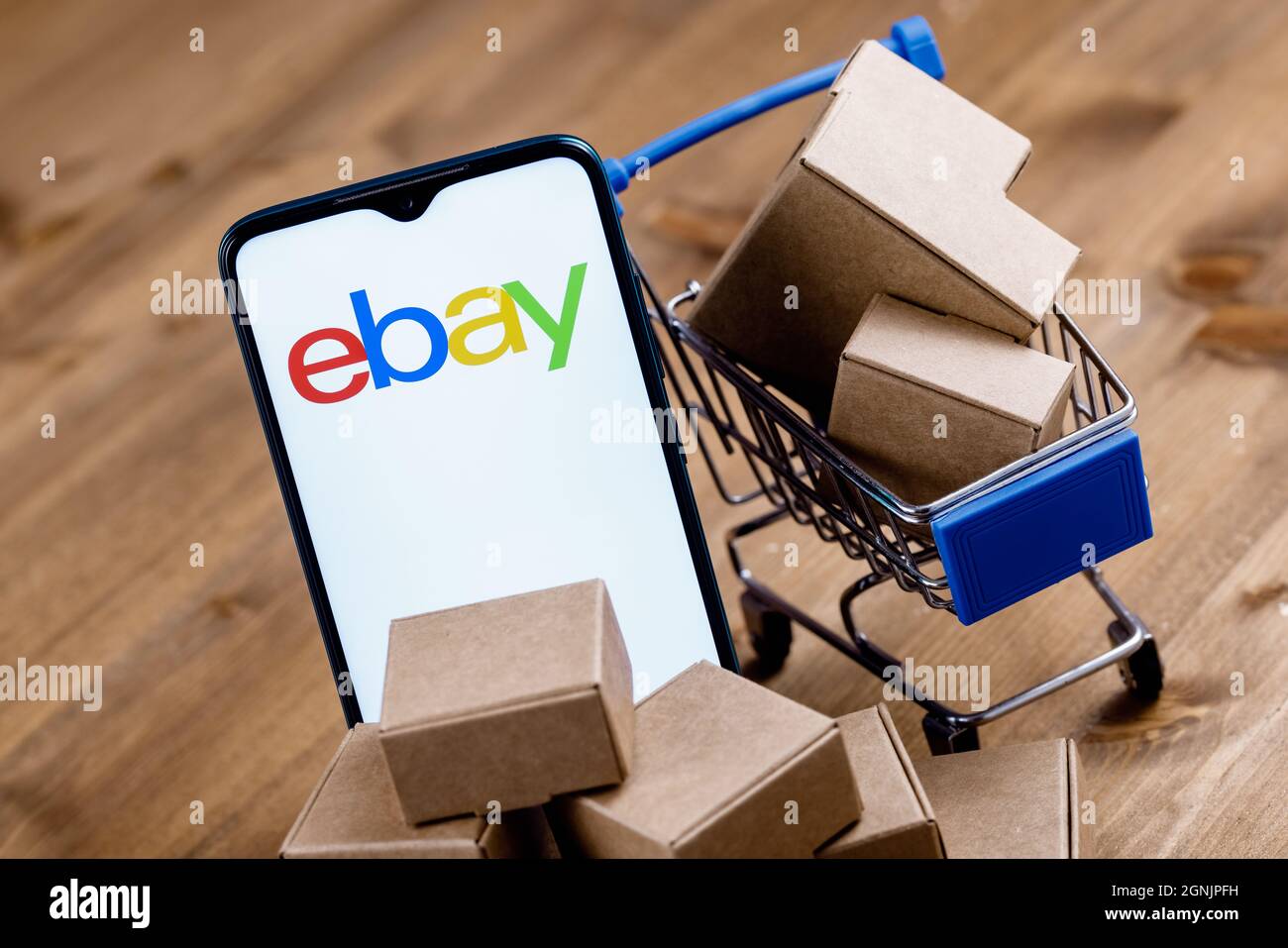 Smartphone with  logo on the screen, shopping cart and parcels