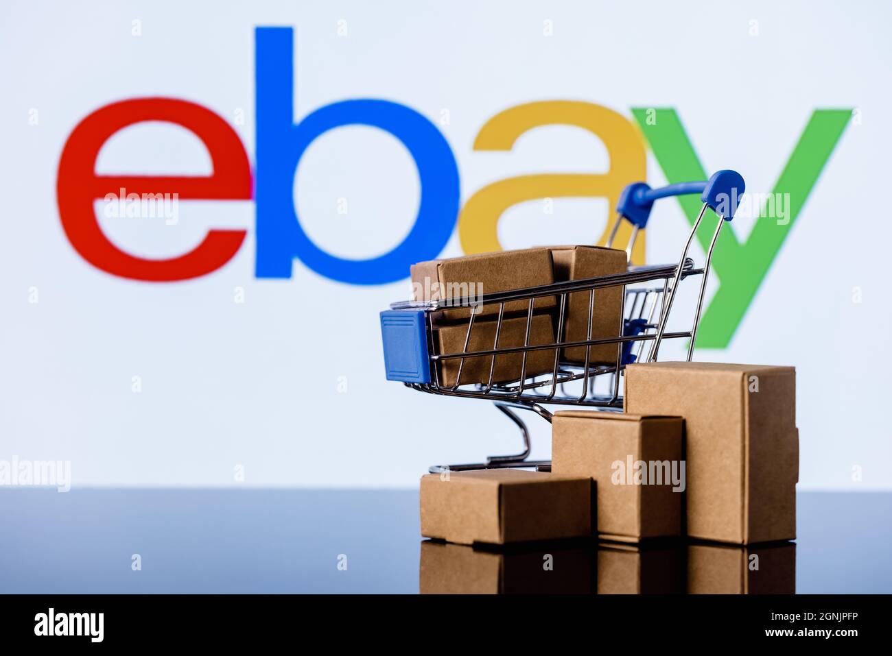 Shopping cart with parcels on the background of the eBay logo Stock Photo Alamy