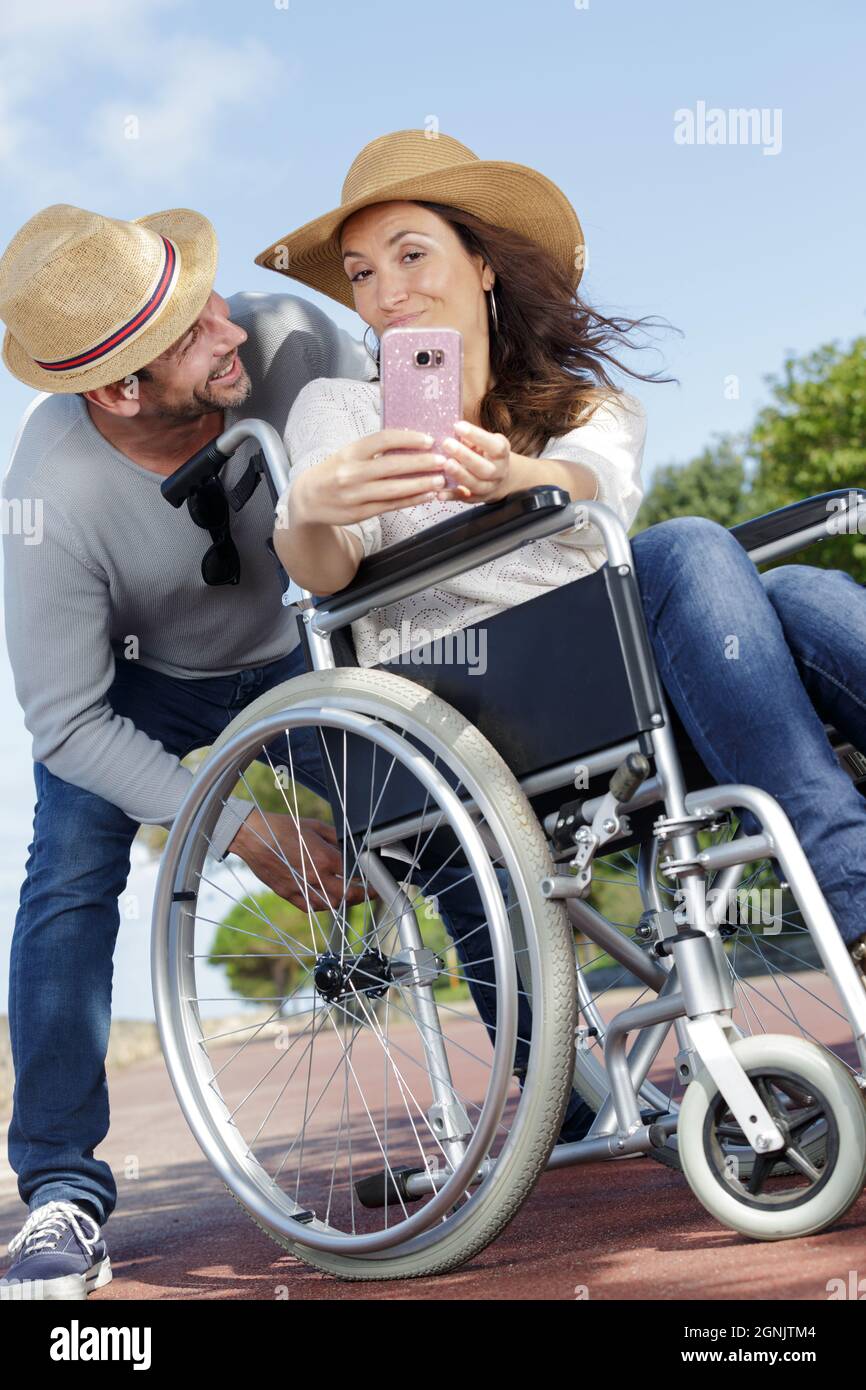 couple in wheelchair taking a selfie Stock Photo - Alamy
