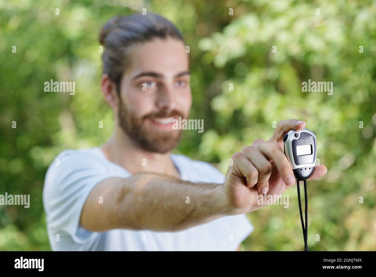 young runner showing stopwatch outdoors Stock Photo Alamy