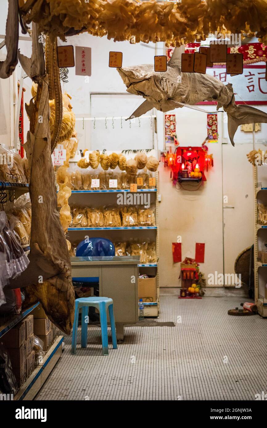 Whole sharks hanging in a shop selling dried seafood products in Tai O, Lantau Island, Hong Kong Stock Photo