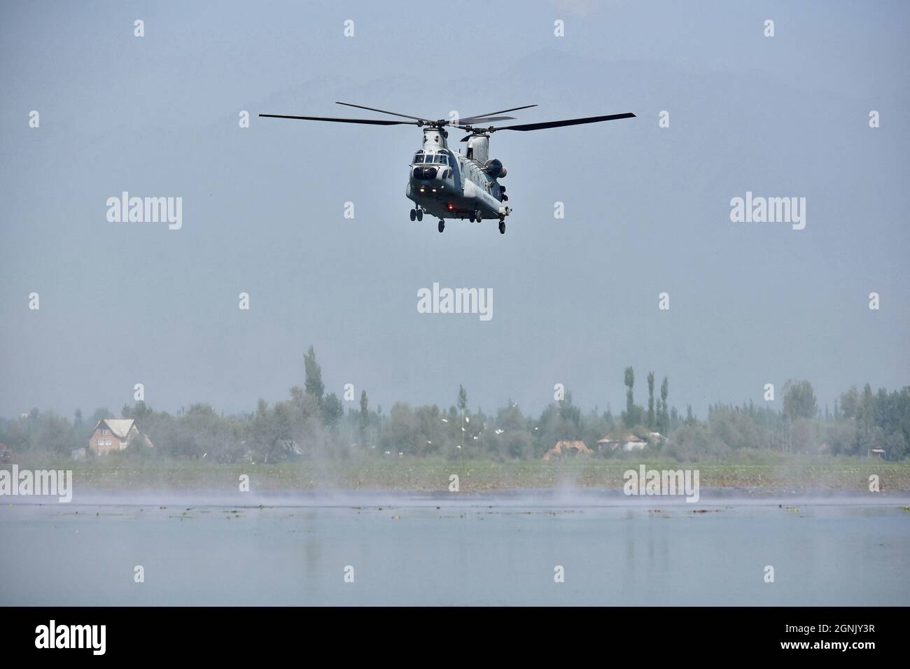 Indian Air Force (IAF) Chinook helicopter flies over the Dal lake during an air show conducted by Indian Air Force (IAF) in Srinagar. After a gap of 13 years, Indian Air Force (IAF) conducted an Air Show over the world famous Dal Lake in Srinagar, an official said.The show saw a display by the IAF’s Surya Kiran Aerobatics Team, Paramotor and powered hang-glider display, fly past MiG-21 Bison, aerobatics by Su-30 Aircraft. It also included Akashganga skydiving display. (Photo by Saqib Majeed / SOPA Images/Sipa USA) Stock Photo