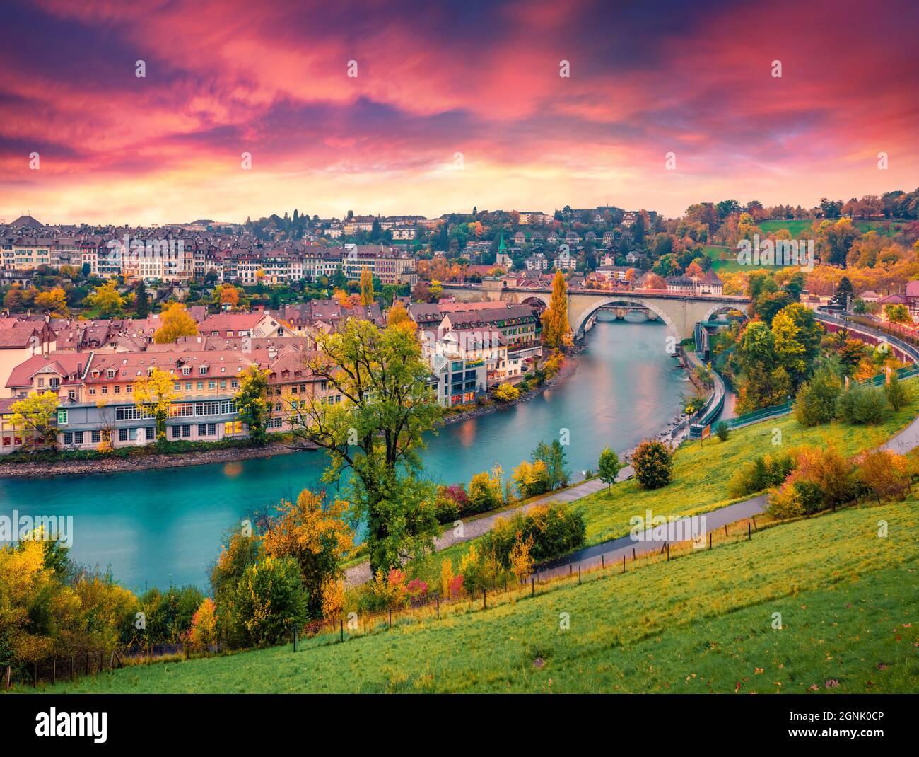 Landscape photography. Fantastic evening view of Bern town with Pont de Nydegg bridge and Nydeggkirche - Protestant church on background. Autumn sunse Stock Photo