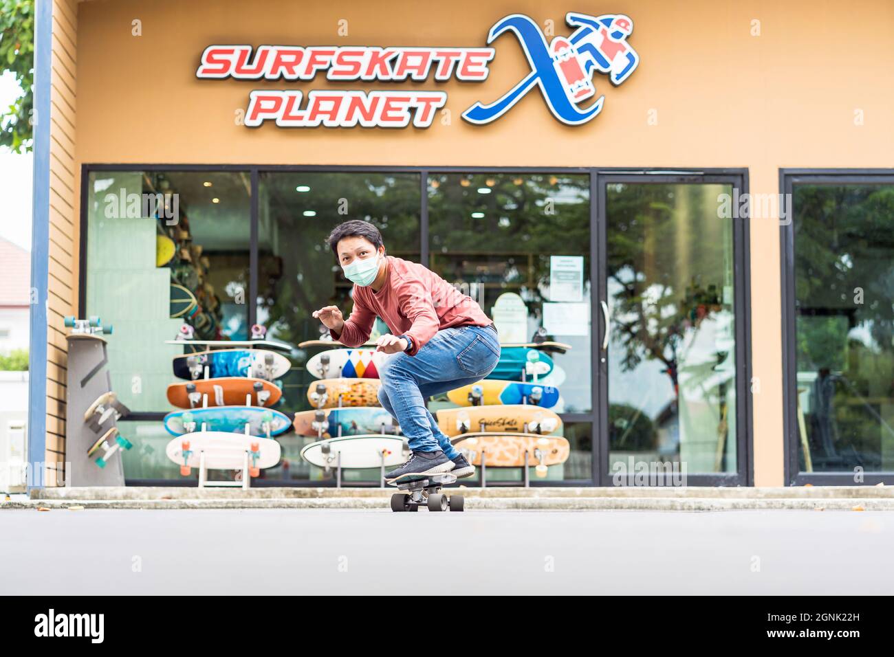 Asian Cheerful man playing surfskate or skateboard in front turn action  over the surfskate planet x store sop at bangkok, Thailand extream sport,  hea Stock Photo - Alamy