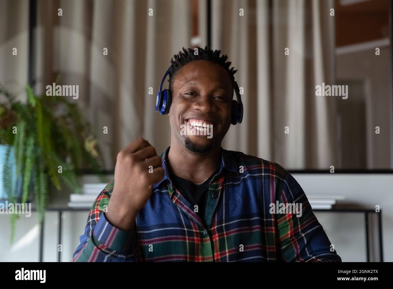 Millennial Black hipster guy in headphones making video call Stock Photo