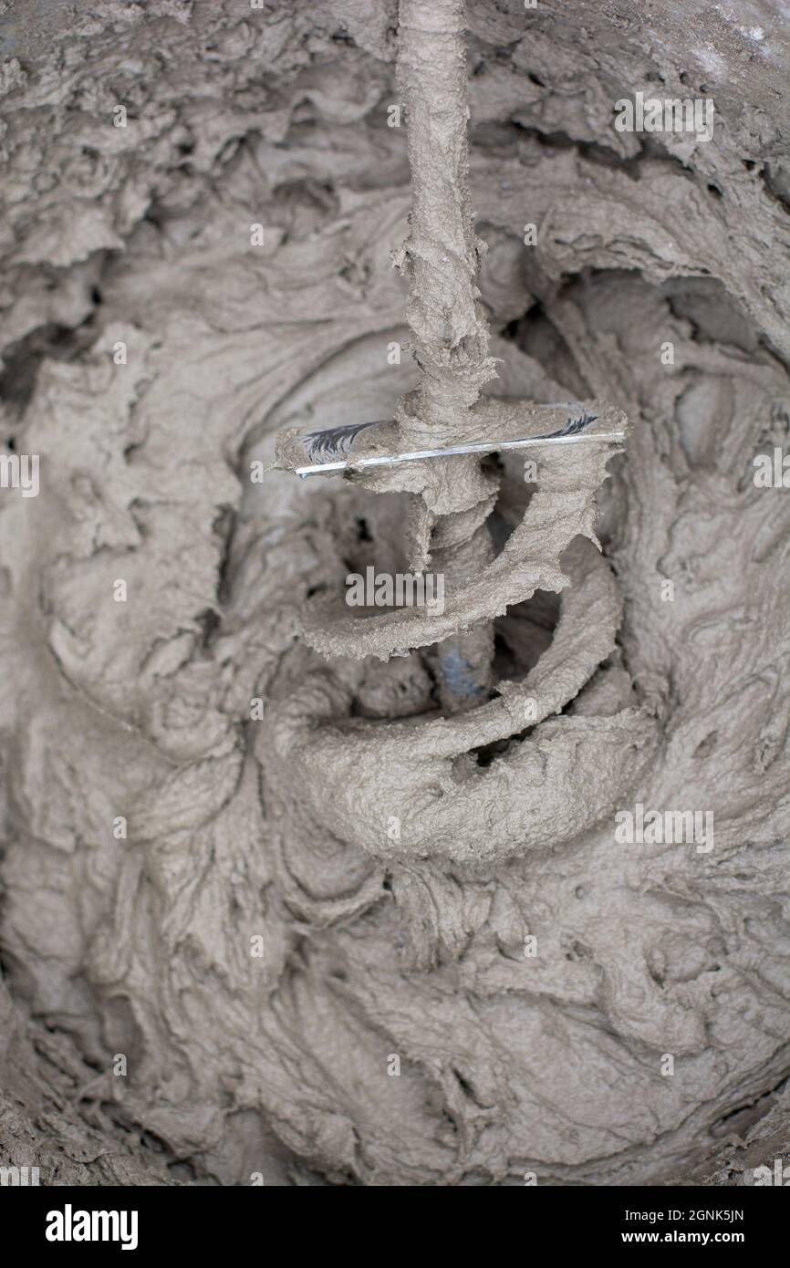 Mixing a plaster solution by an electric drill. Adhesive mixing. Home