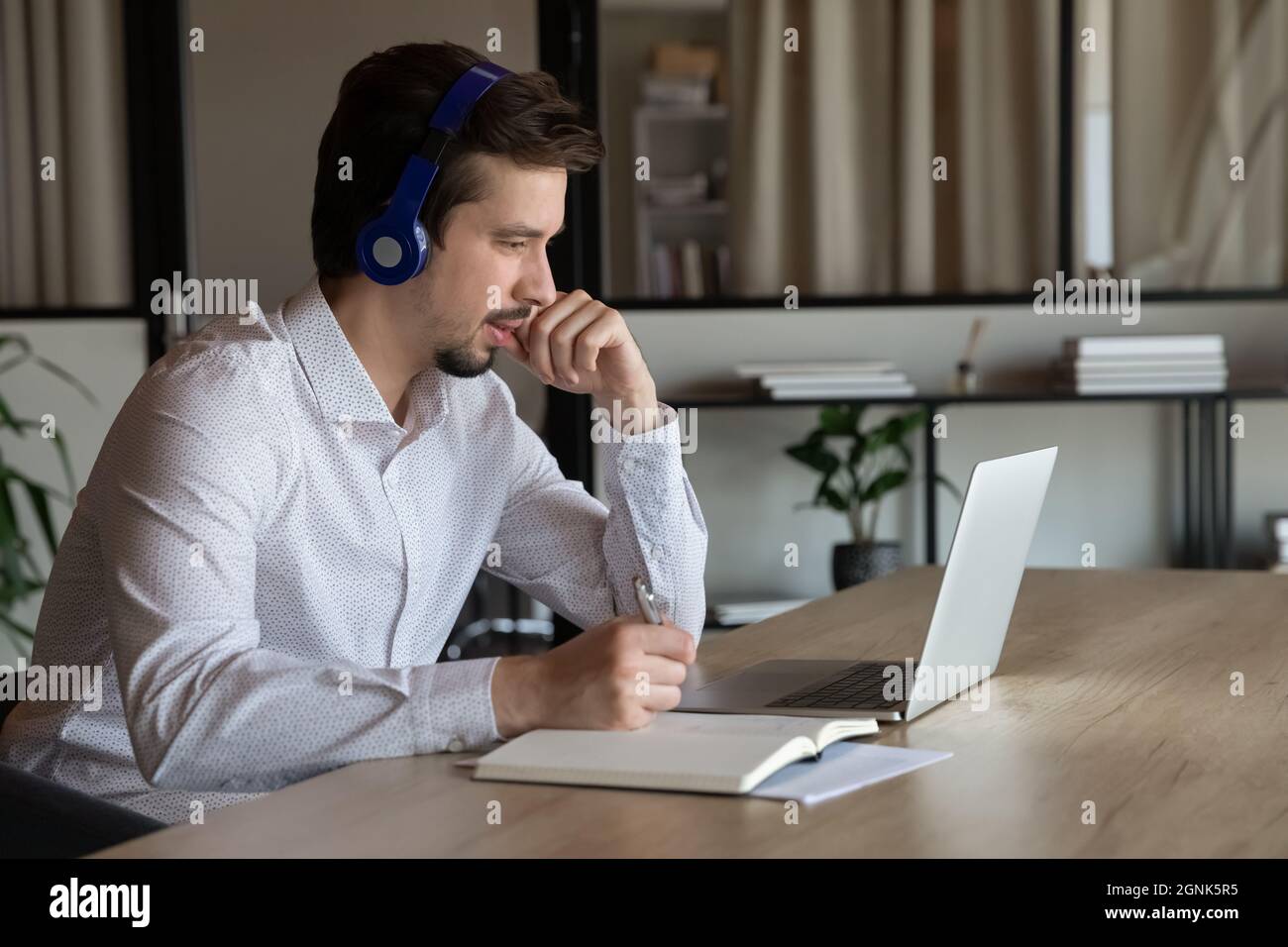 Employee, manager in headset making video call to client Stock Photo