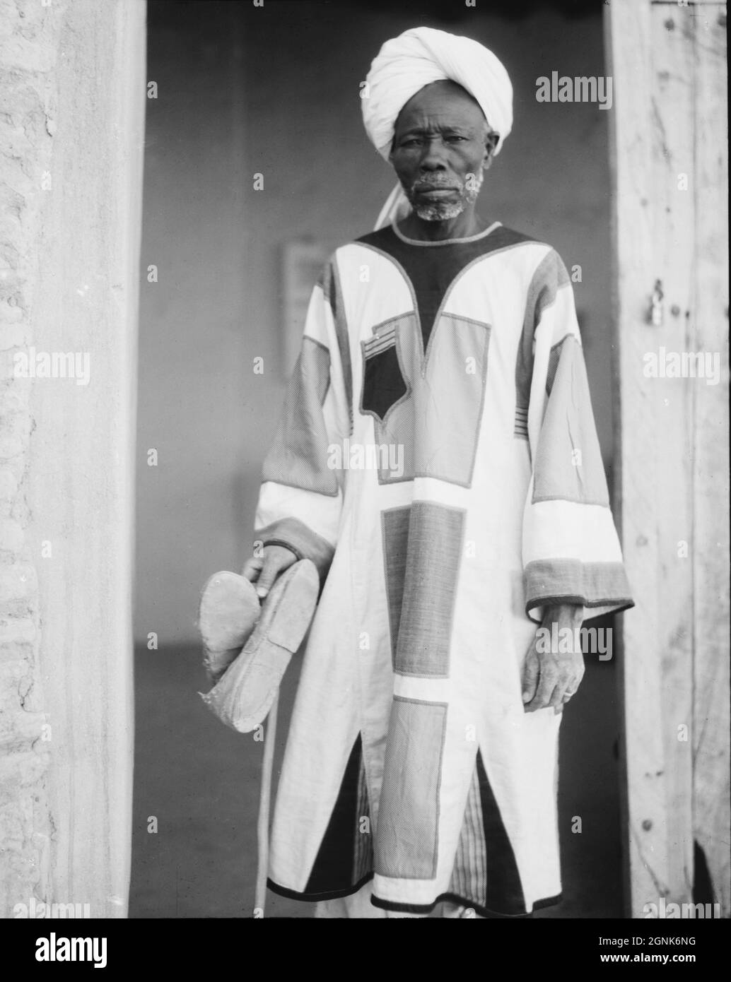 Early 20th century photo circa 1936 a Sudanese man wearing a traditional jibba or jibbah worm by members of the Mahdist Army of the 1880 to 1890s Stock Photo