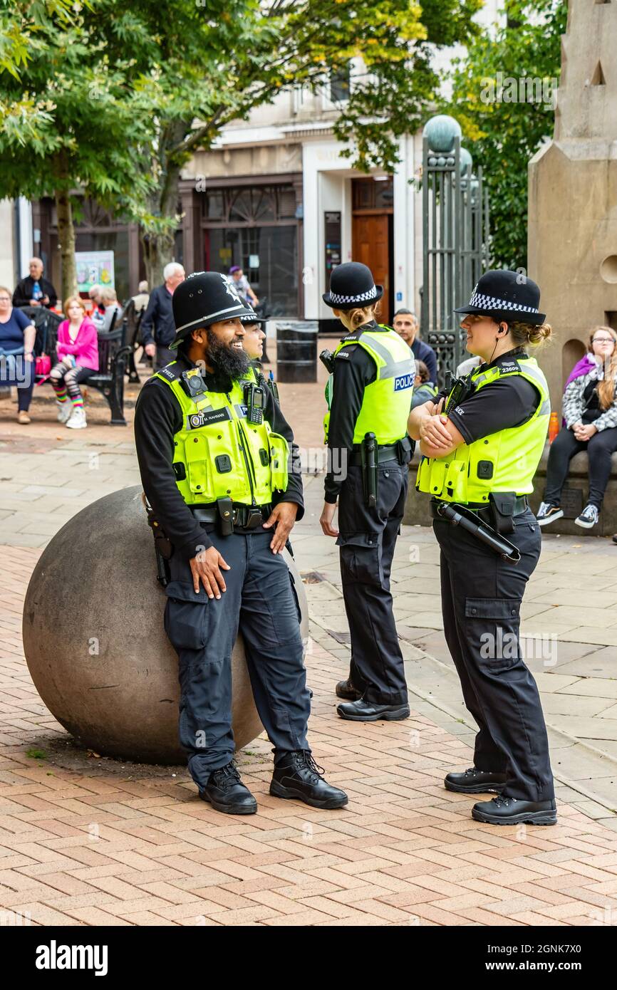 bearded asian police officer talks to white female officer at Birmingham Pride Saturday 25th September 2021 Stock Photo