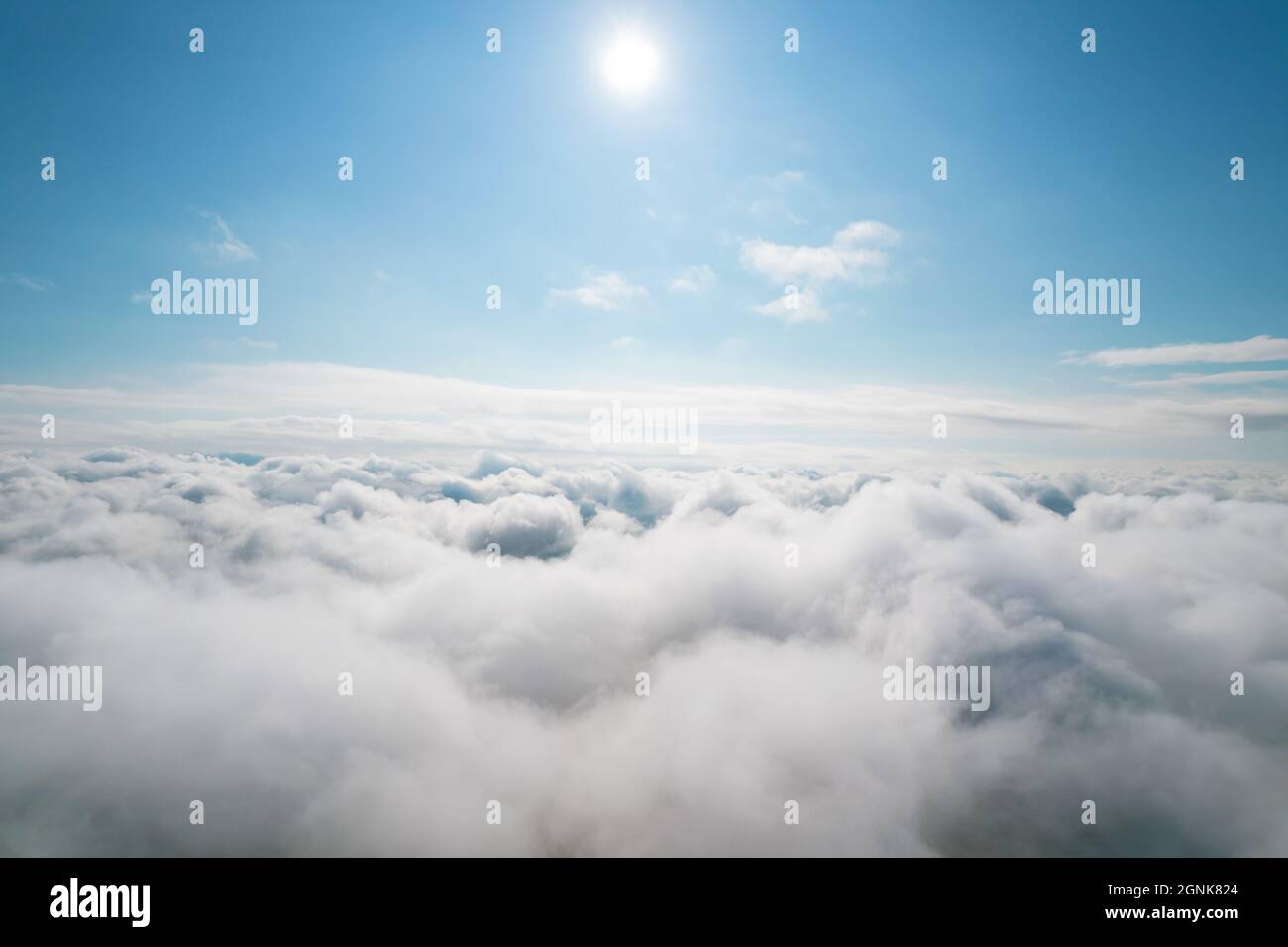 Aerial shot of white fluffy clouds and some blue sky in the distance ...