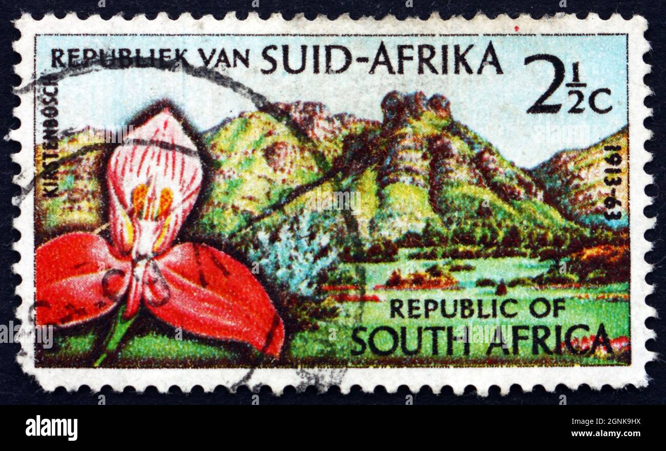 SOUTH AFRICA - CIRCA 1963: a stamp printed in South Africa shows Red Disa Orchid, Castle Rock and Kirstenbosch Botanic Gardens, Cape Town, circa 1963 Stock Photo