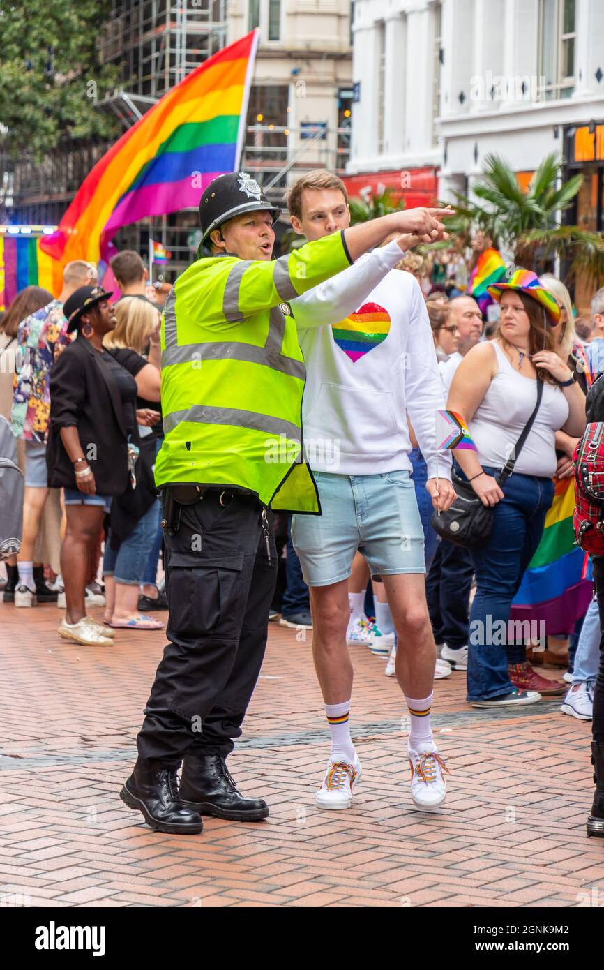 policeman directing young man with rainbow heart on sweatshirt at Birmingham Pride Saturday 25th September 2021 Stock Photo