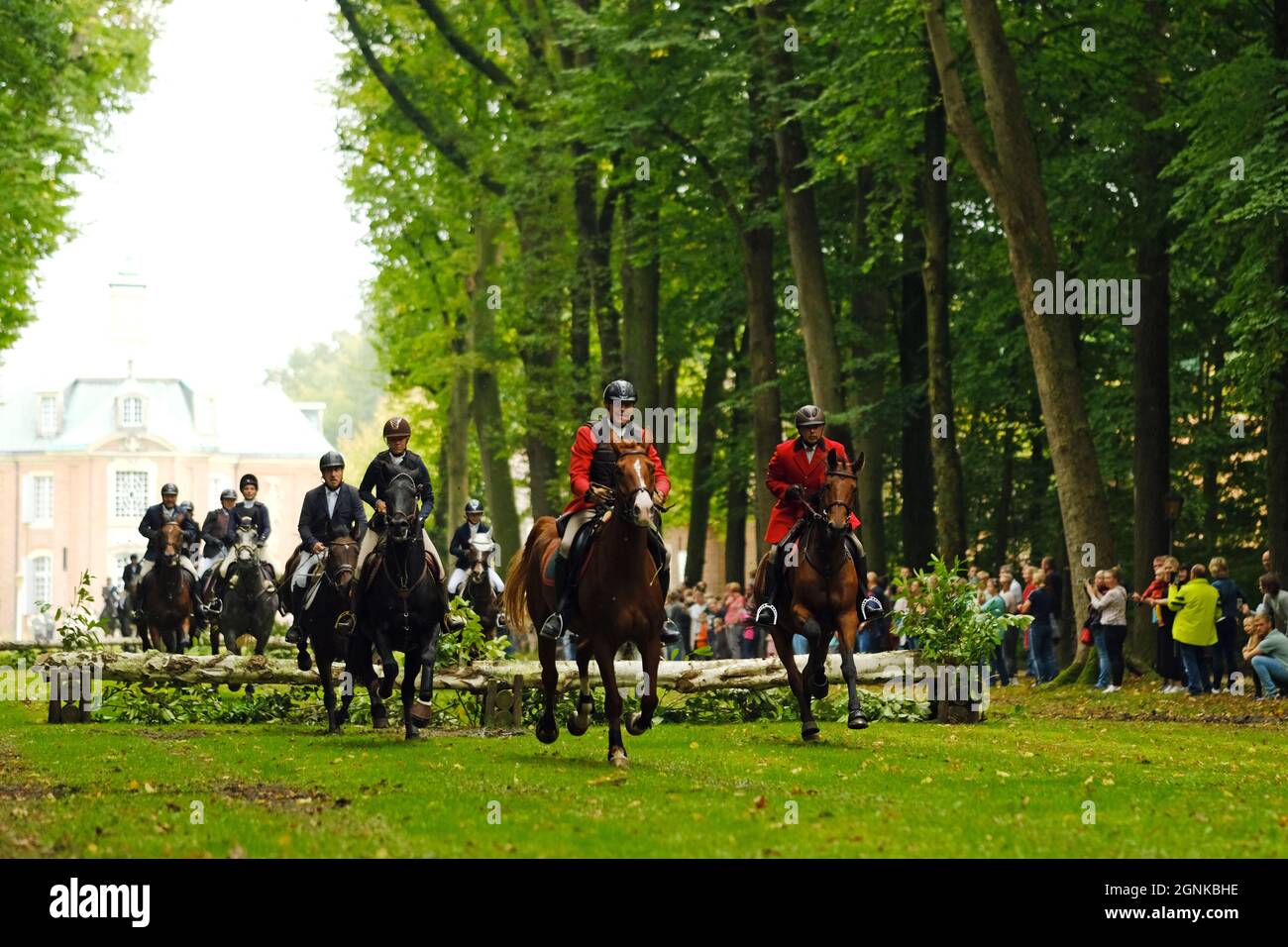 26 September 2021, Lower Saxony, Sögel: Riders ride along the avenue at Clemenswerth Castle. They follow the Cappenberg hound pack and are part of the traditional hunt over the Hümmling. Photo: Markus Hibbeler/dpa Stock Photo
