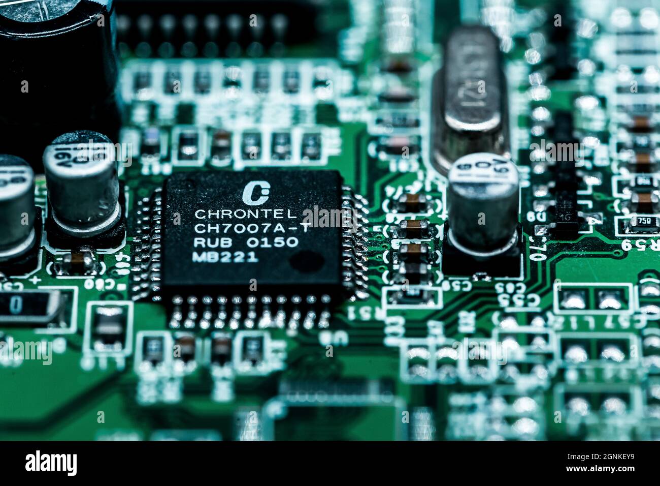 A macro shot of a green electronic circuit board with its small details ...