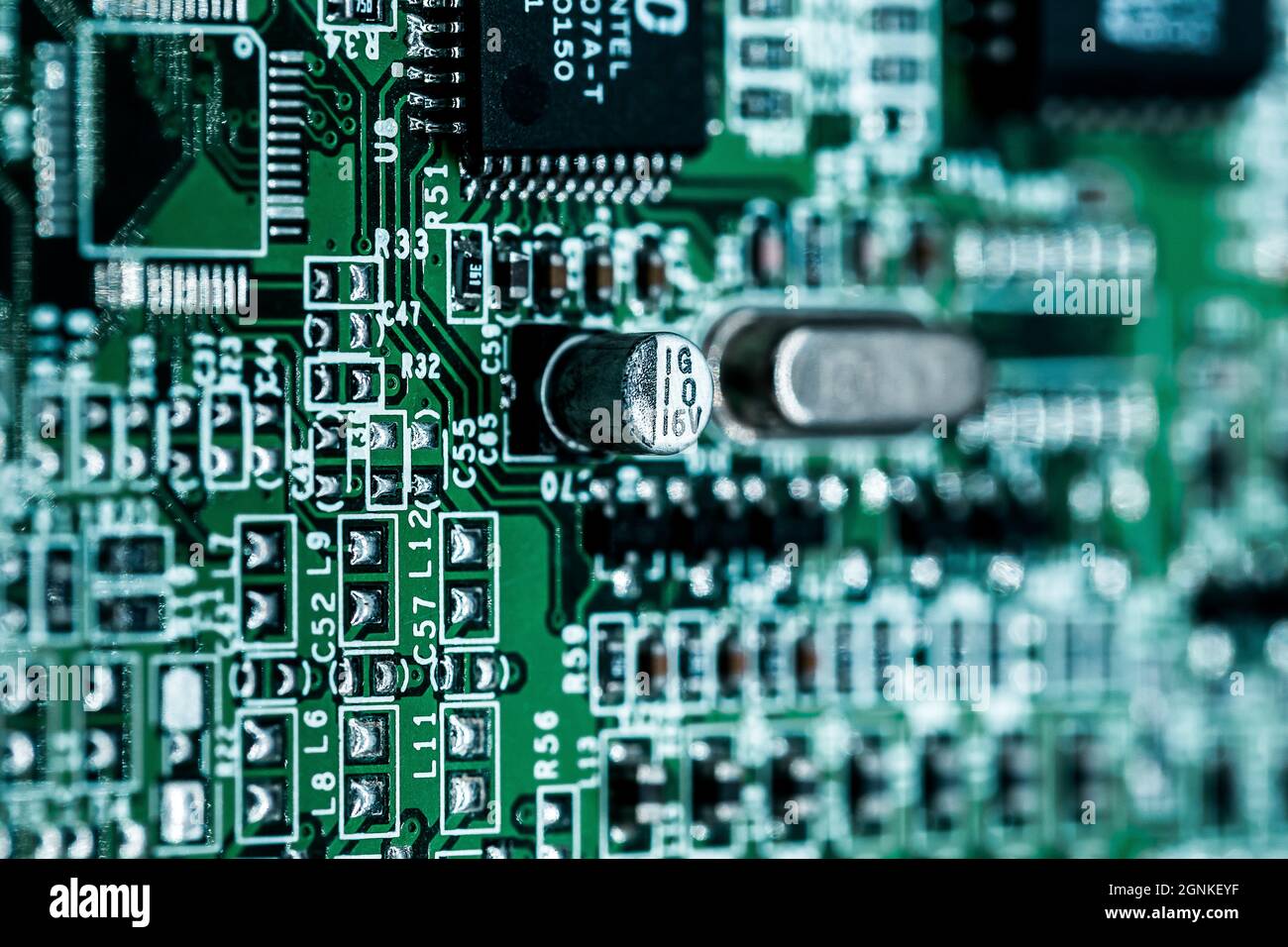 A macro shot of a green electronic circuit board with its small details ...