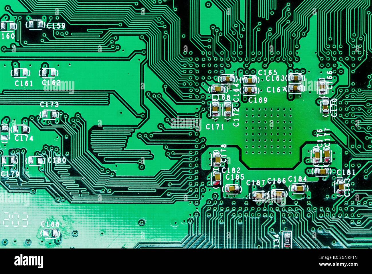 A macro shot of a green electronic circuit board with its small details ...