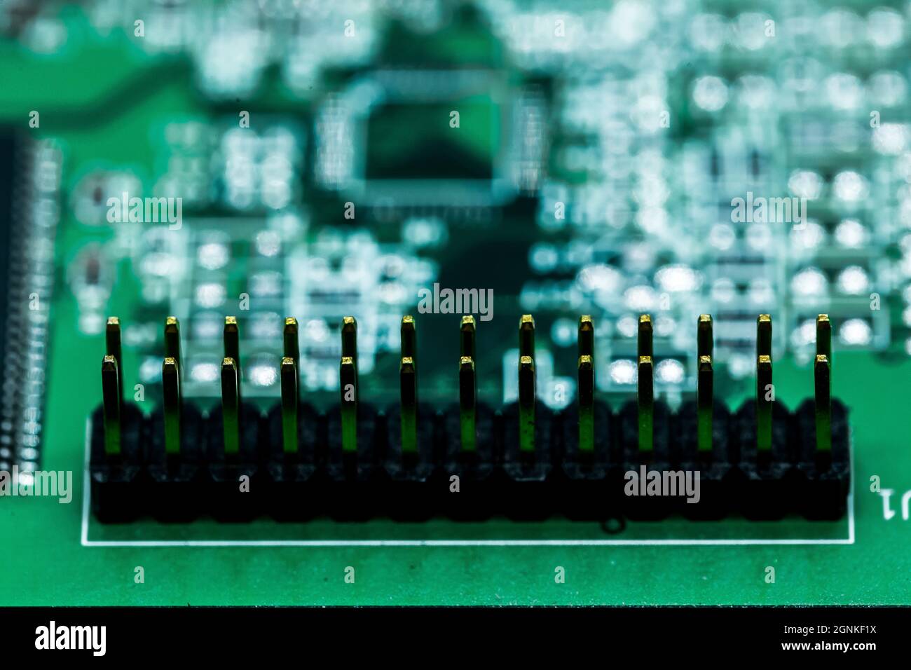 A macro shot of a green electronic circuit board with its small details ...