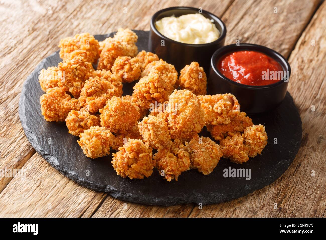 Spicy Chicken popcorn breaded deep fried served with two sauces close