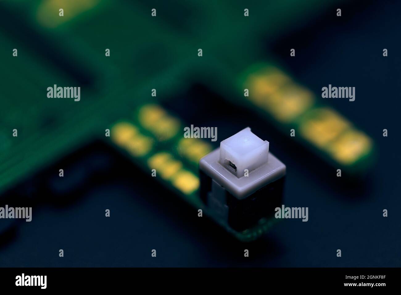 A macro shot of a green electronic circuit board with a very small ...