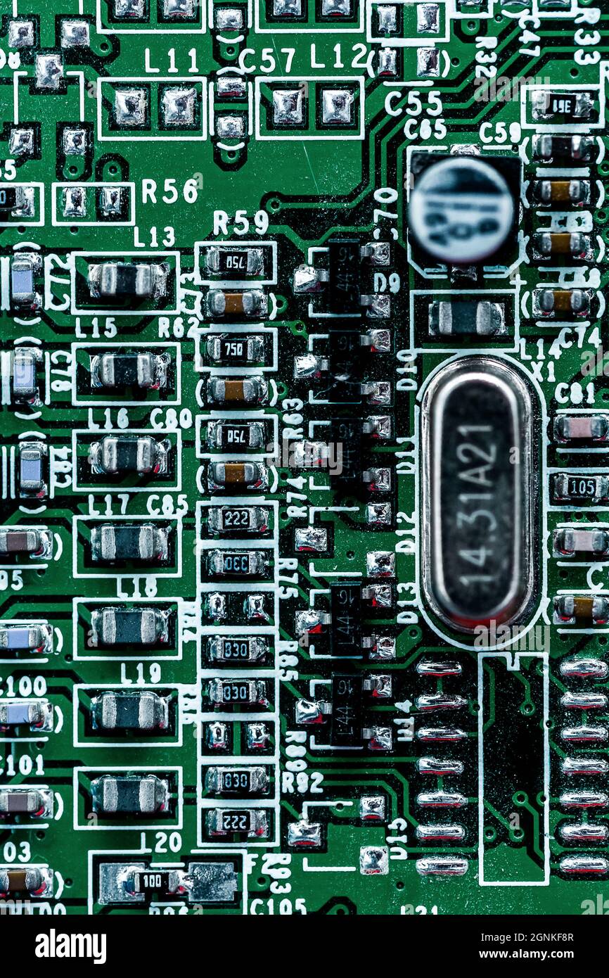 A macro shot of a green electronic circuit board with its small details ...