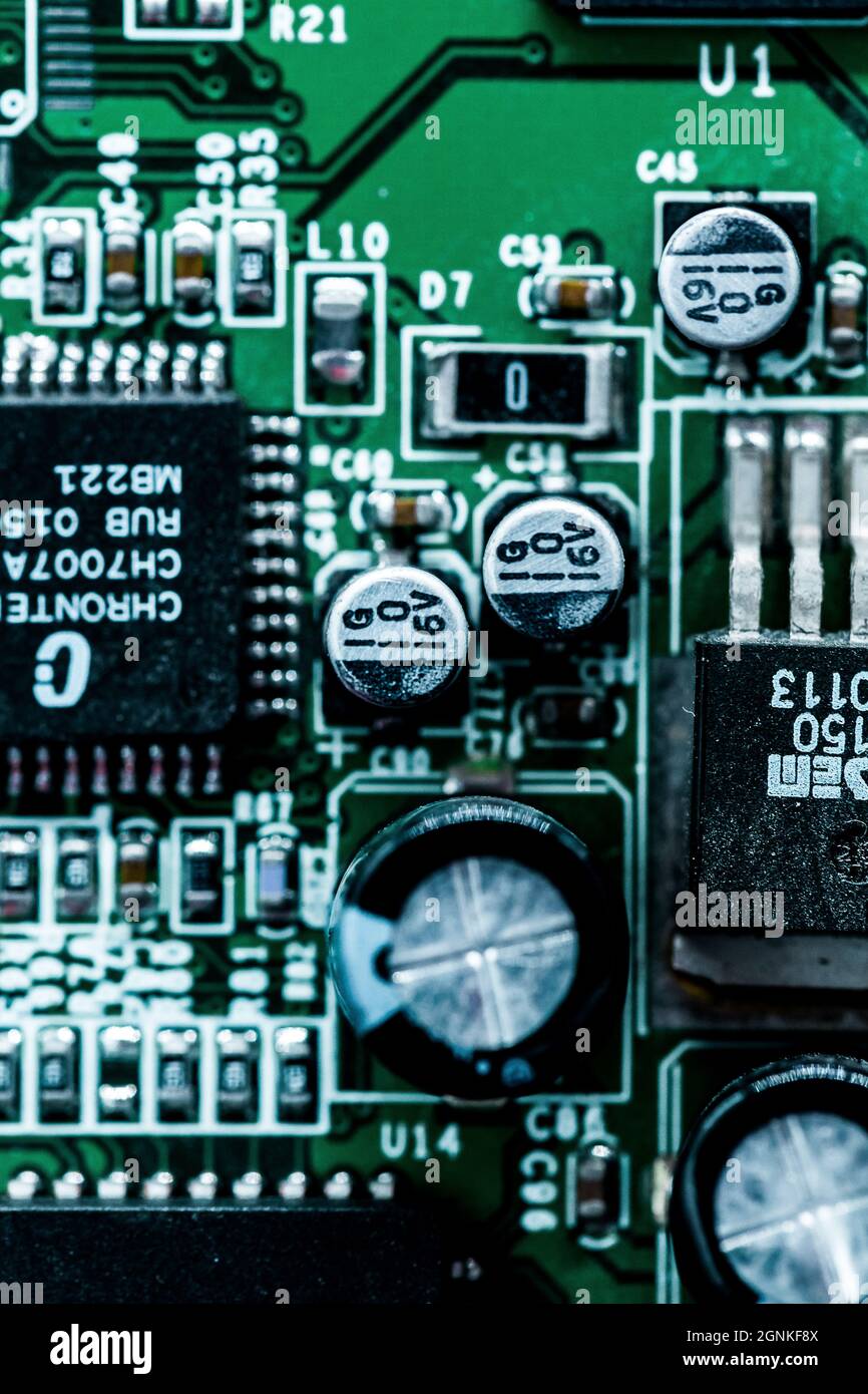 A macro shot of a green electronic circuit board with its small details ...