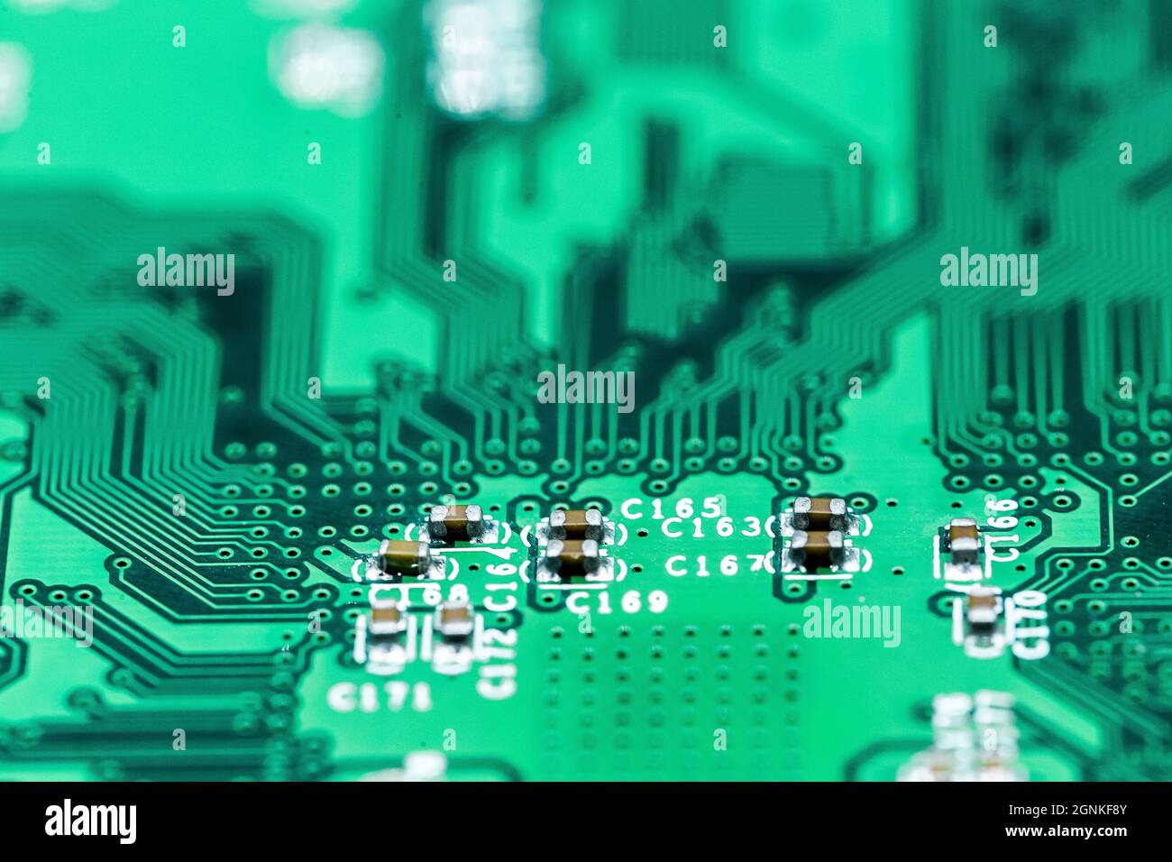 A macro shot of a green electronic circuit board with its small details ...
