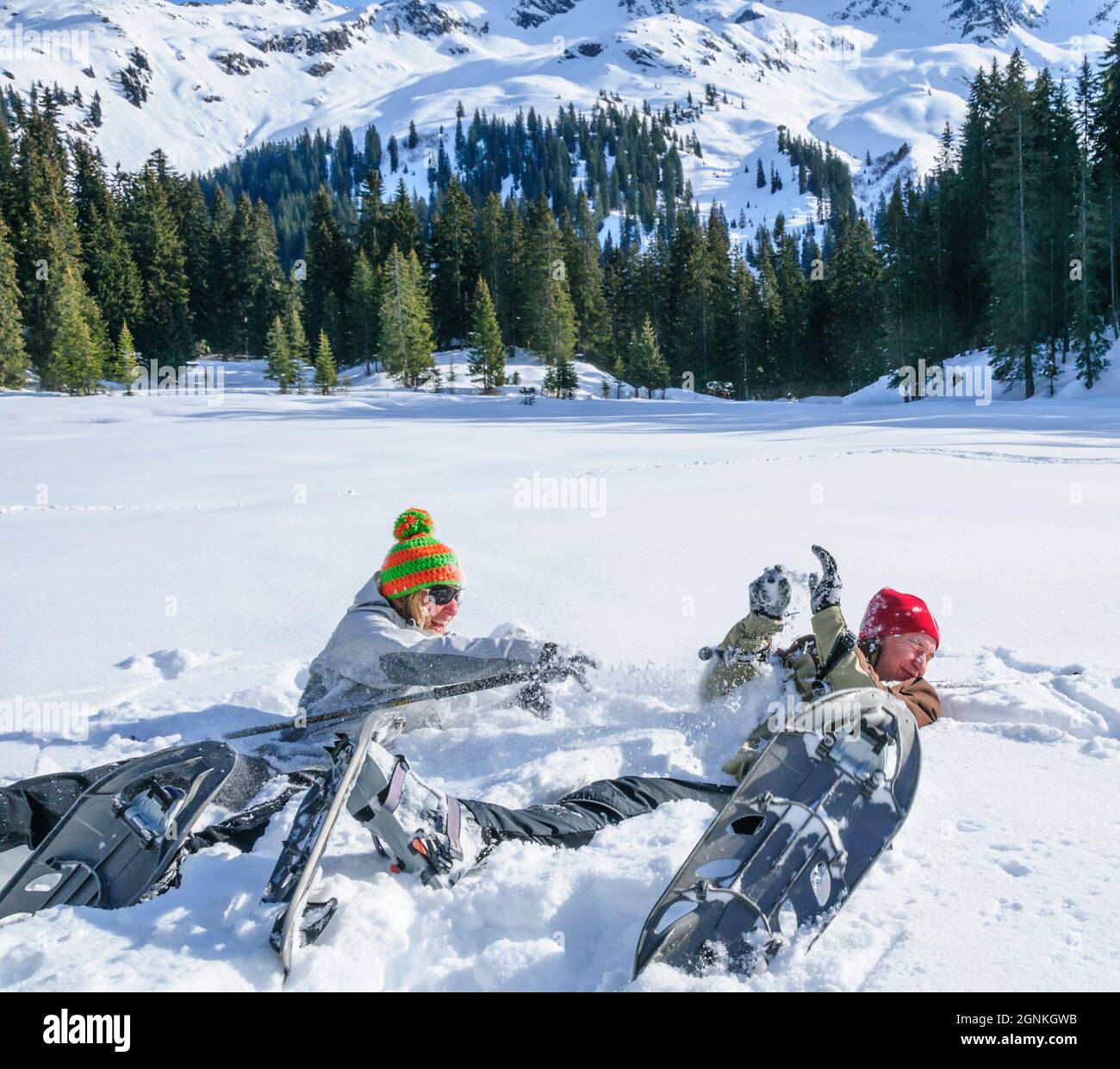 Happy couple playing in snow during snowshoe tour Stock Photo - Alamy