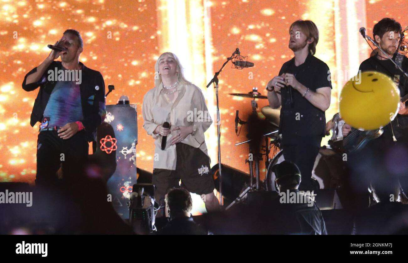 Coldplay band members performing on stage in year 2021