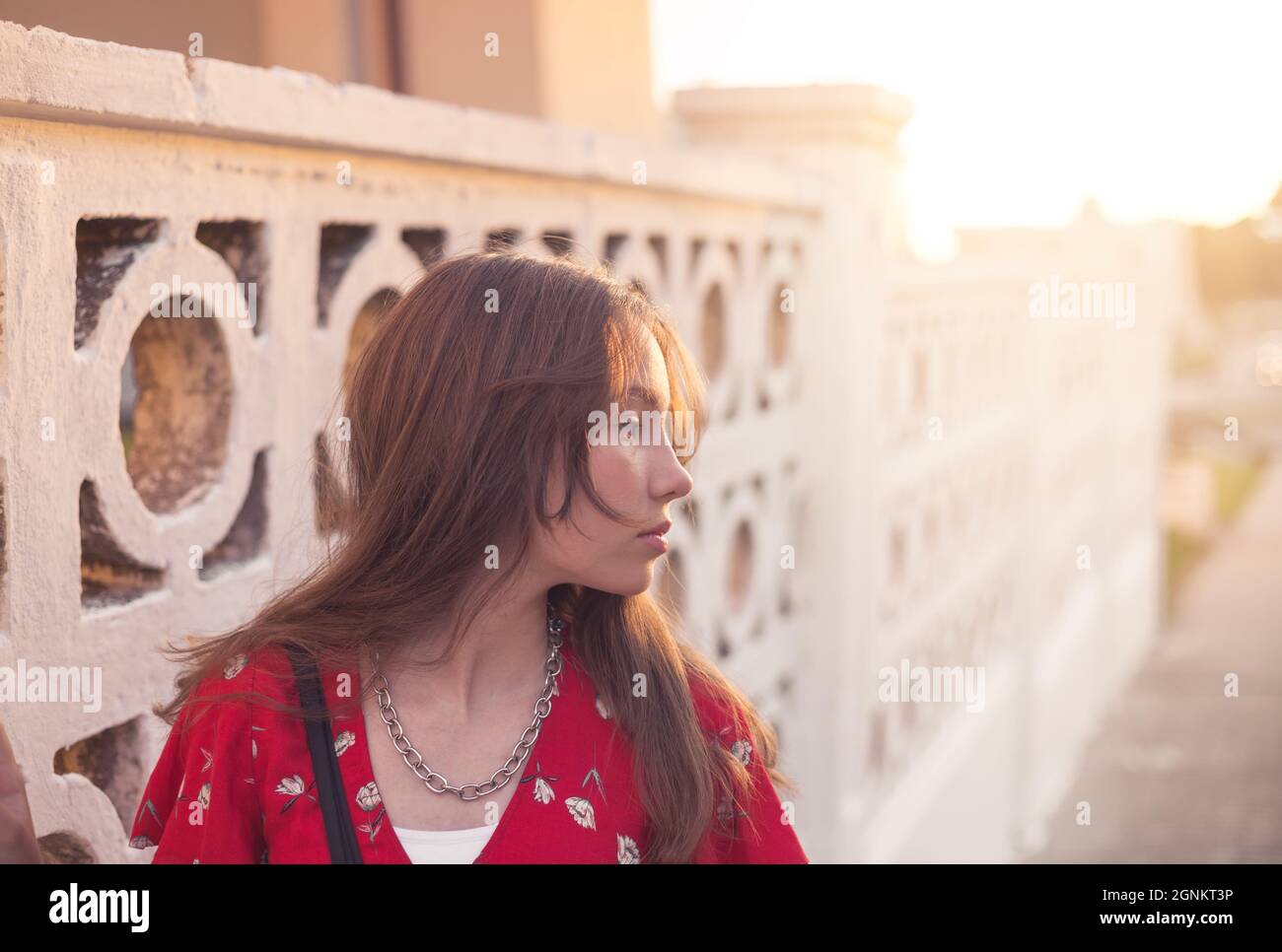 Portrait of a sad teenager girl is dreaming  outdoors at summer evening Stock Photo