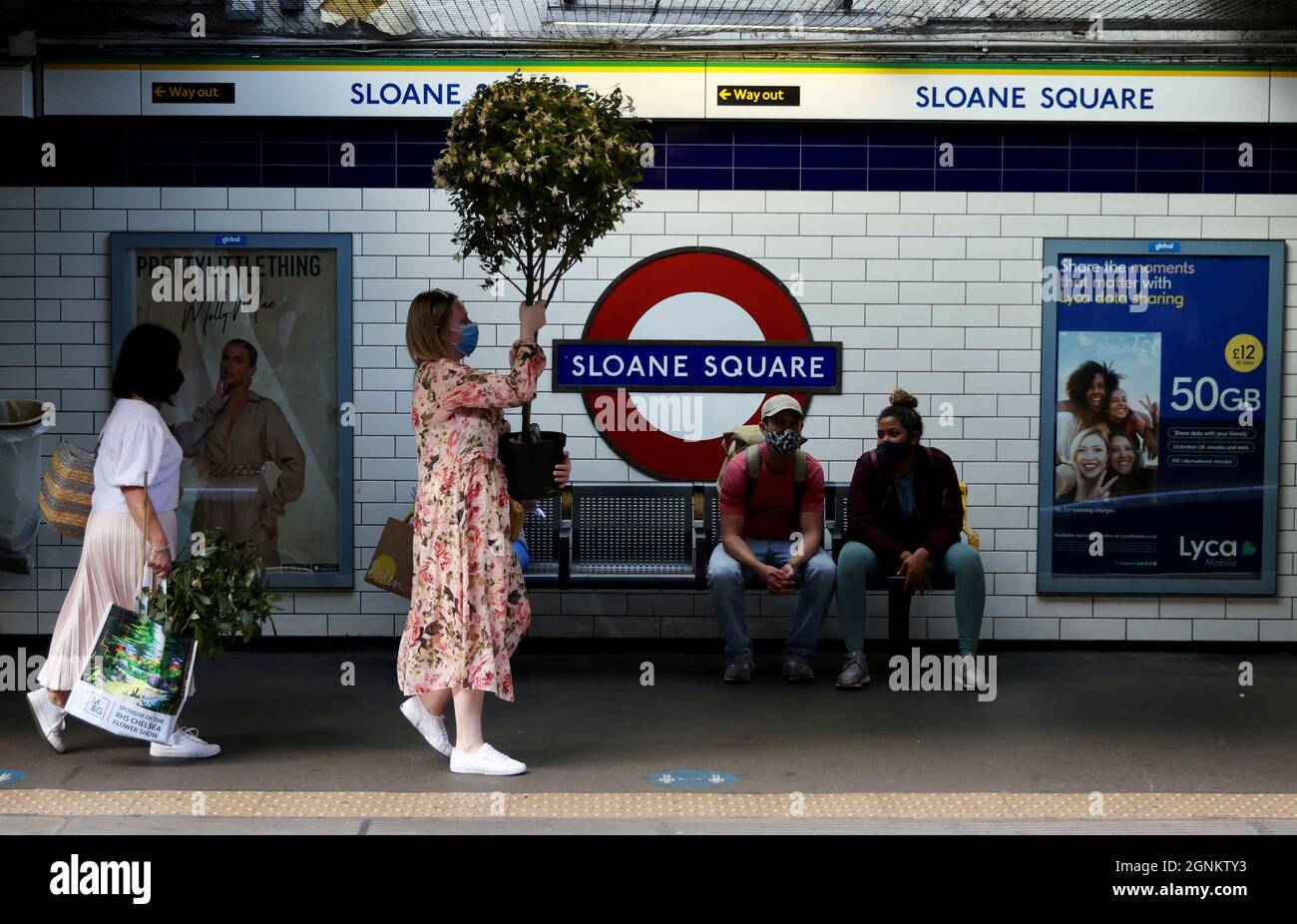 People wait on the platform at Sloane Square tube station after the last day of Chelsea Flower Show in London, Britain, September 26, 2021.   REUTERS/Kevin Coombs Stock Photo