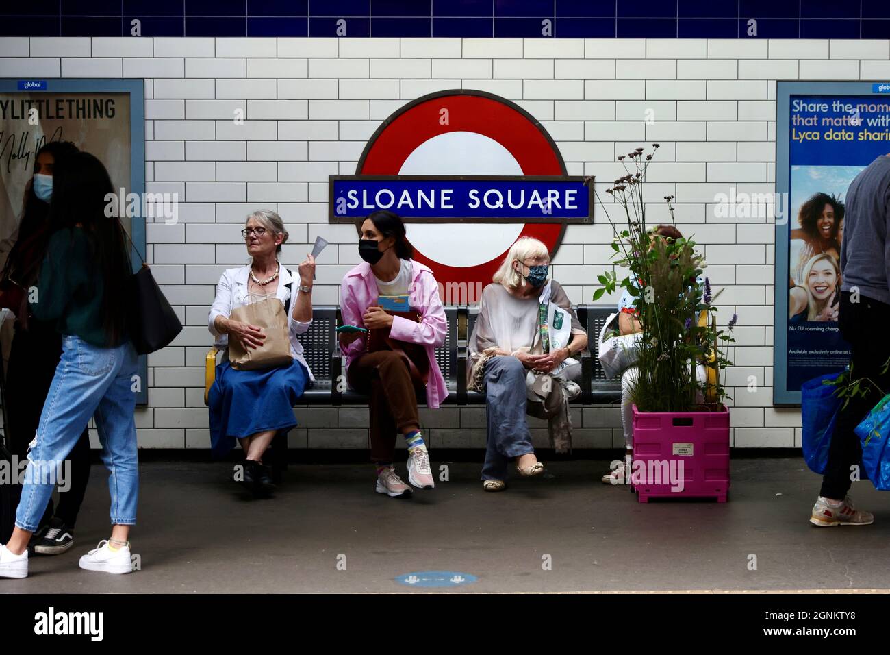 People wait on the platform at Sloane Square tube station after the last day of Chelsea Flower Show in London, Britain, September 26, 2021.   REUTERS/Kevin Coombs Stock Photo