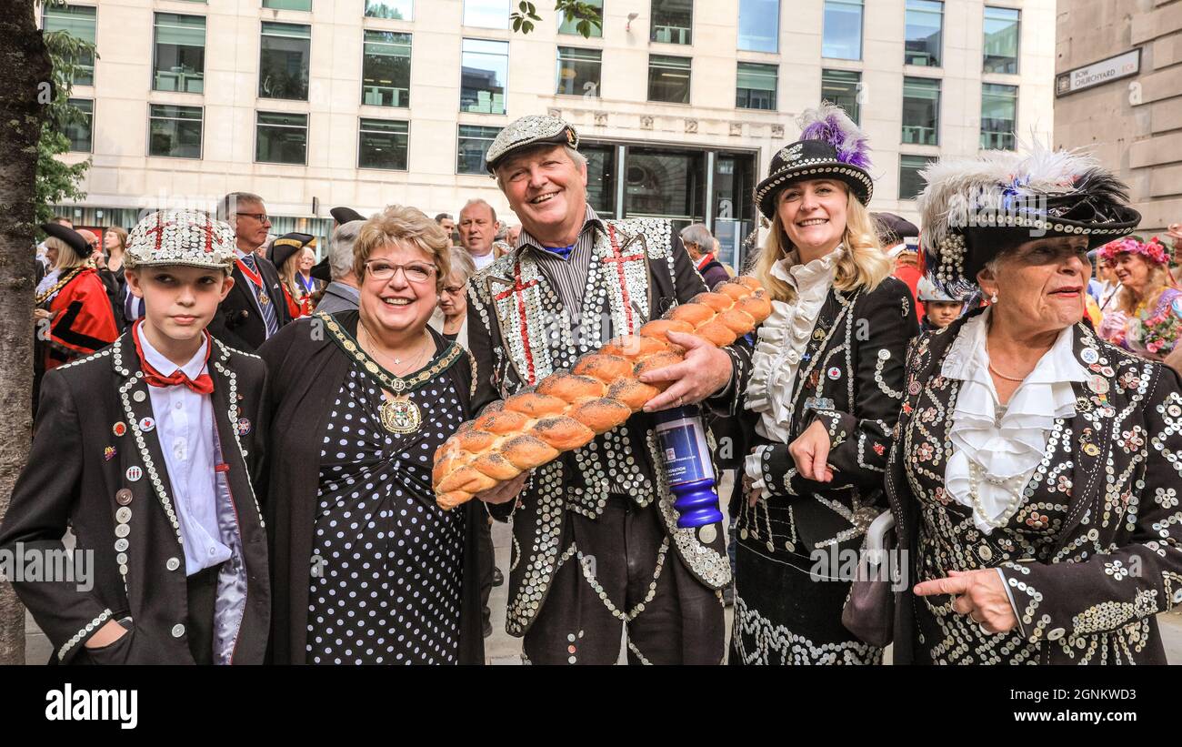 St Mary-Le-Bow, London, UK. 26th Sep, 2021. A Pearly King with his Prince and Princess brings a loaf of bread offering to the Costermonger's Harvest service. Pearly Kings and Queens celebrate their annual harvest festival with the Costermonger´s Harvest Service at St Mary-Le-Bow church. As the usual celebrations in Guildhall Yard had to be cancelled, the Pearlies meet and greet friends and the public outside the church before and after service his year. Credit: Imageplotter/Alamy Live News Stock Photo