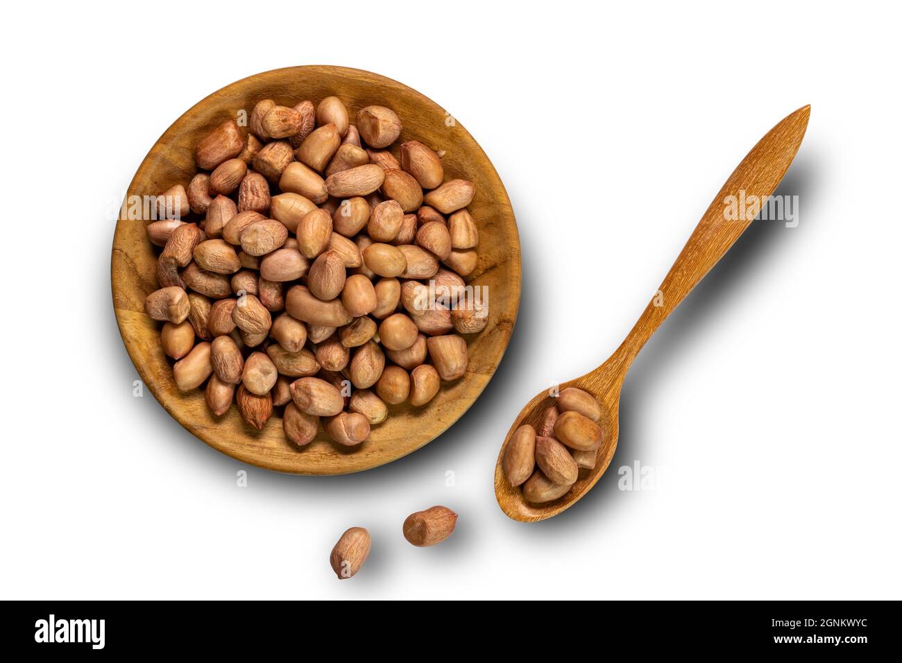 Peanut in wooden plate and in wooden spoon isolated on white background with clipping path. Stock Photo