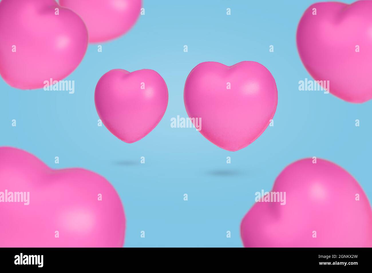 Creative idea with floating hearts in the air on pastel blue background ...